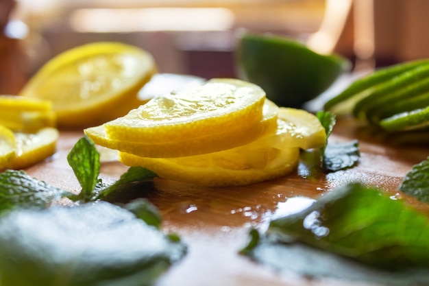 Sliced fresh lemons and lime wooden table