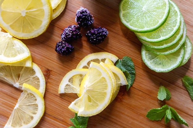 Sliced fresh lemons and lime wooden table