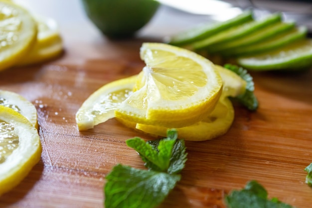 Sliced fresh lemons and lime wooden table