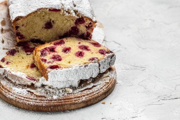 Sliced fruit bread with berries for dessert cupcake sweet bread with cherries Homemade sponge cake or chiffon cake on white table Homemade bakery concept place for text top view