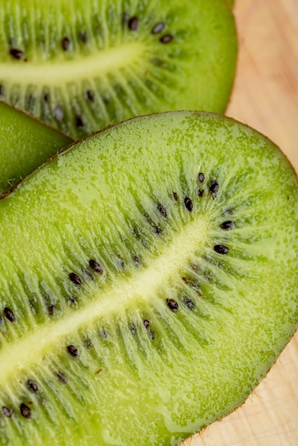 Sliced green ripe kiwi are lying on the table cooking a dish with ripe kiwi fruit