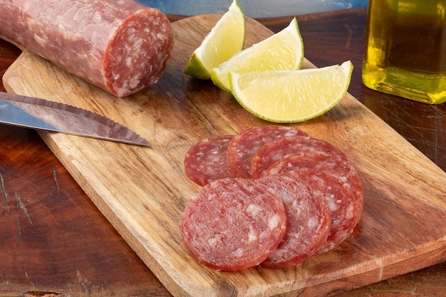 Sliced Italian salami spread on cutting board