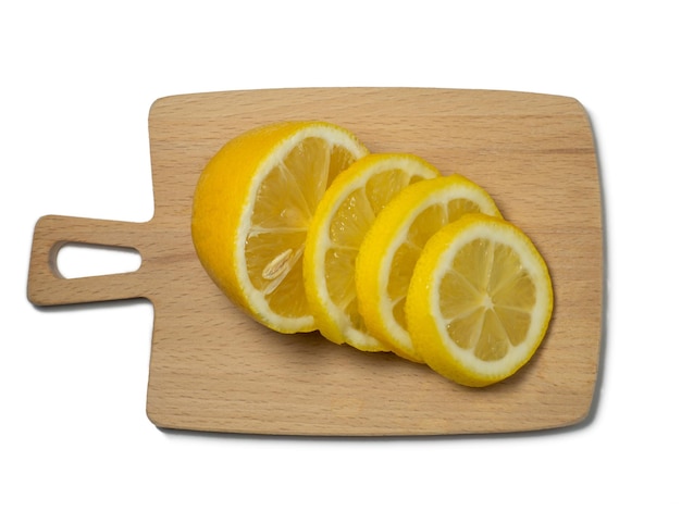 A sliced lemon on a small cutting board on a yellow background Citrus on the table Bright background Healthy fortified food for a diet