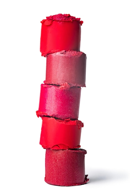 Sliced lipstick pieces stacked together isolated on a white background. Close-up of cut lipstick pieces stacked