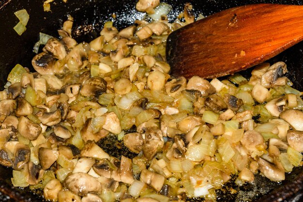 Sliced mushrooms roast with onion in a pan