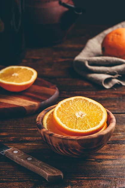 Sliced orange in a wooden bowl