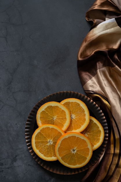 Sliced oranges on vintage golden plate