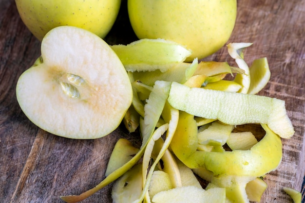 Sliced and peeled green apple on a wooden board