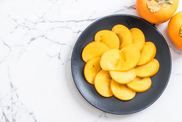 sliced persimmon on plate