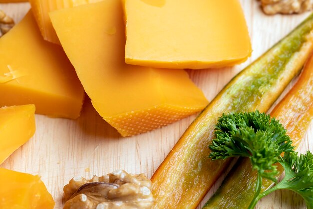 Sliced piece of orange cheese made from milk with walnuts fresh orange cheese and other food products