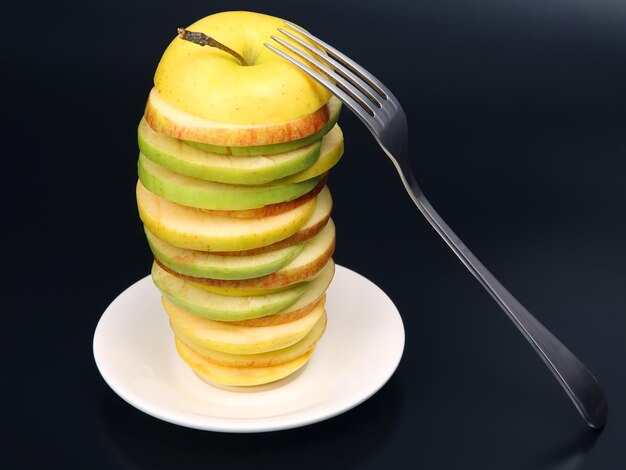 Sliced pieces of different apples on a white plate