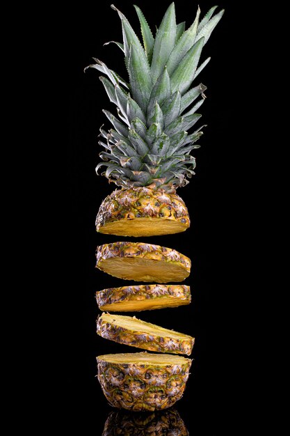 Sliced pineapple black isolated . Healthy tropical fruit eating.Pineapple fall rings.