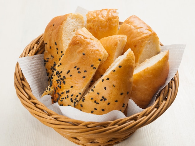 Sliced pita bread with sesame seeds in a wicker basket