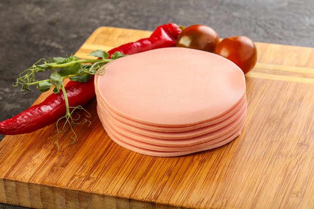 Sliced pork sausages stack over board