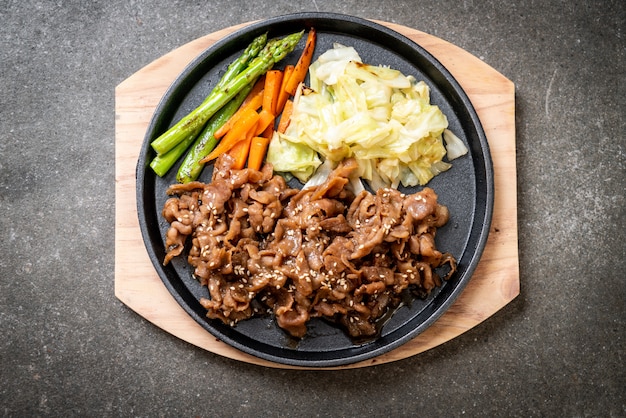 sliced pork steak on hot plate 