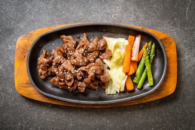 sliced pork steak on hot plate 