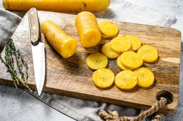 Sliced raw Yellow organic carrots on a cutting Board