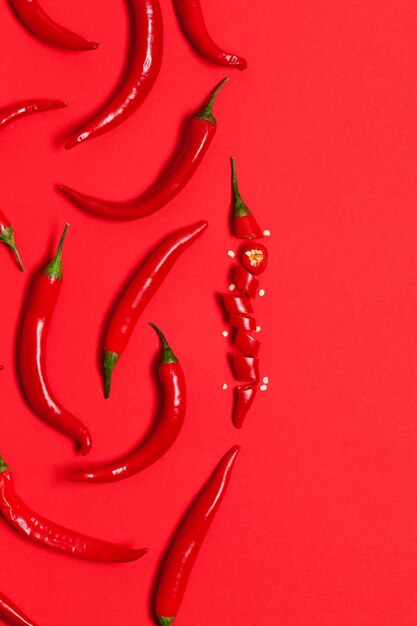 Sliced red chili pepper arranged on a bright red background