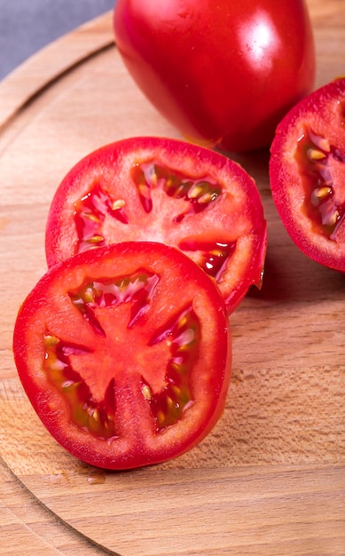 Sliced red tomato on a cutting board for cooking