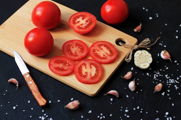 sliced red tomatoes with salt and garlic