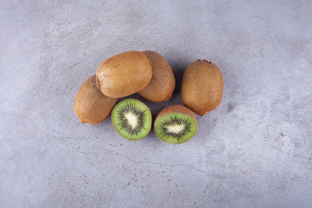 Sliced ripe delicious kiwi placed on stone.