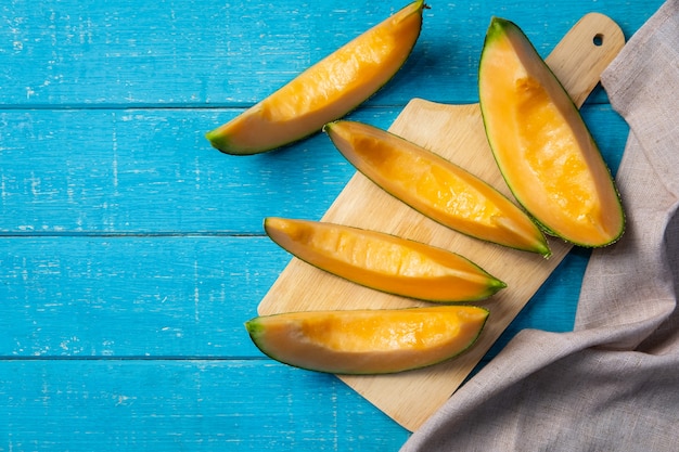 Sliced ripe melon on wooden table