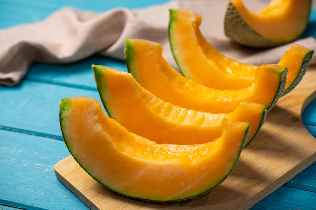 Sliced ripe melon on wooden table