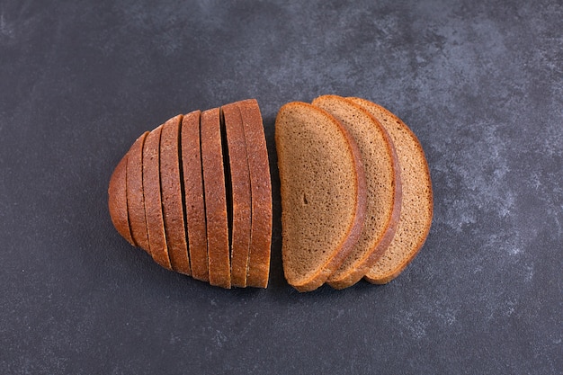 Sliced rye bread on a black table