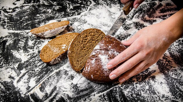 Sliced rye bread on a Board with flour.