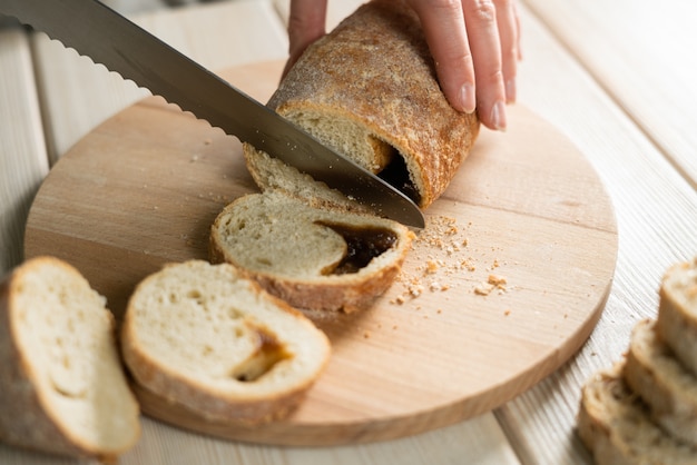 Sliced rye bread on cutting board. Whole grain rye bread with seeds