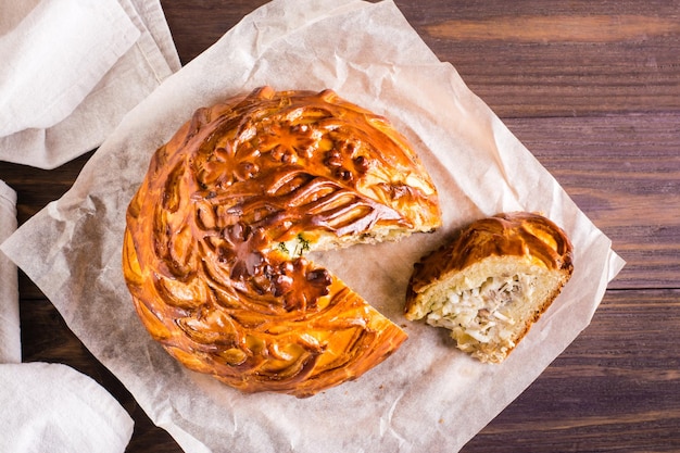 Sliced savory pie with chicken potatoes and rice Homemade pastries Top view Closeup