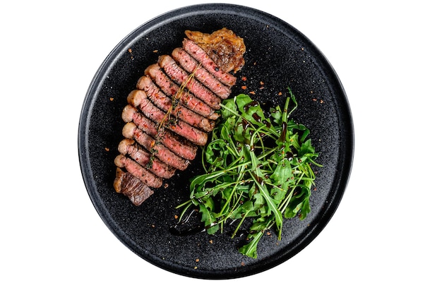 Sliced sirloin steak marbled beef meat with arugula Isolated on white background