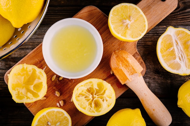 Sliced and squeezed lemon halves on a wooden background view from above