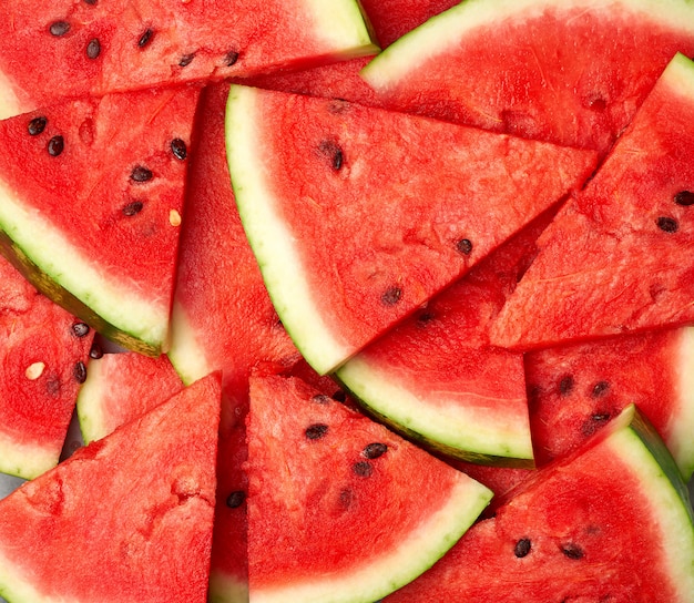 Sliced triangular slices of ripe red watermelon with seeds 