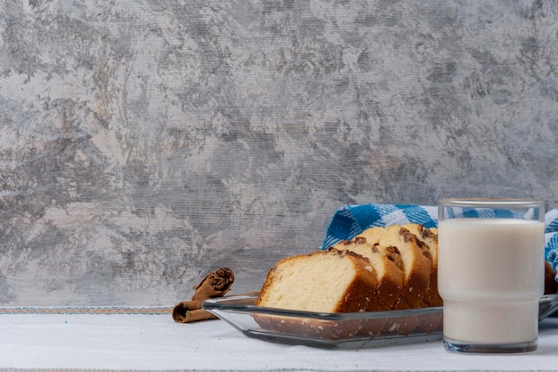 Sliced walnut banana bread accompanied by a glass of milk