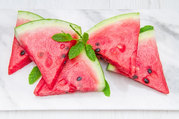 Sliced watermelon on white marble table