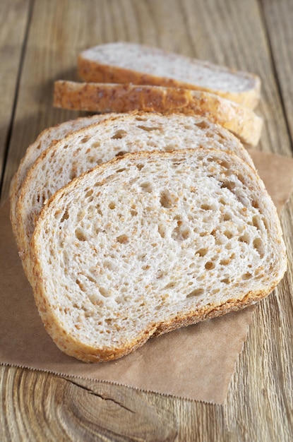 Sliced wheat bread with bran on the wooden table