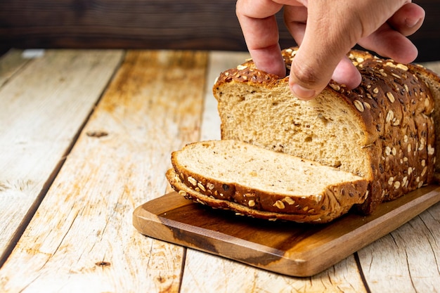 Sliced wholemeal bread with cereal over wooden table