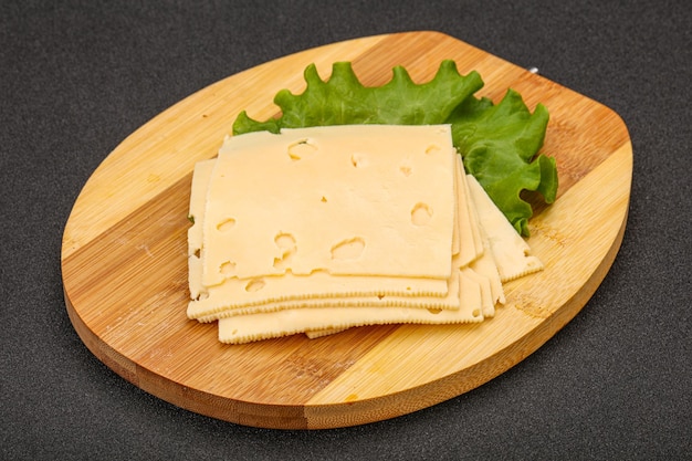 Sliced yellow cheese over board