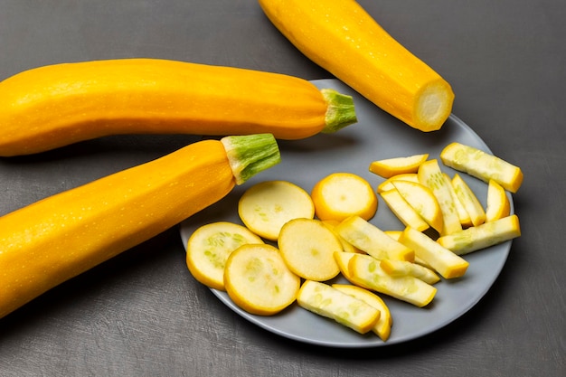 Sliced zucchini on a gray plate Zucchini on the table