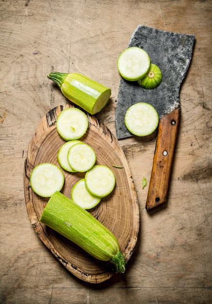 Sliced zucchini and an old hatchet .