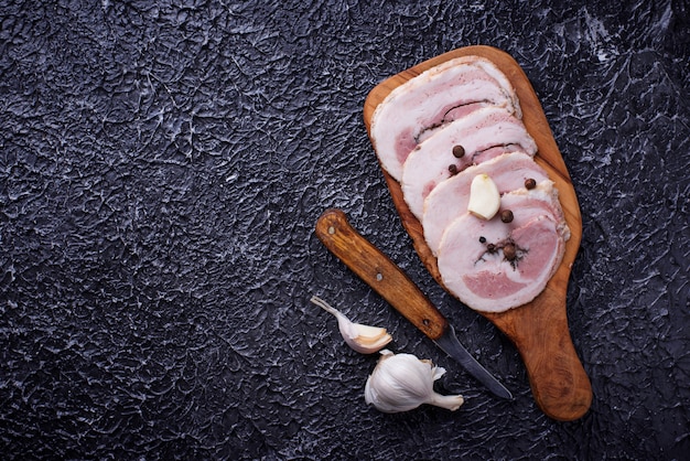 Slices of bacon with pepper and garlic 