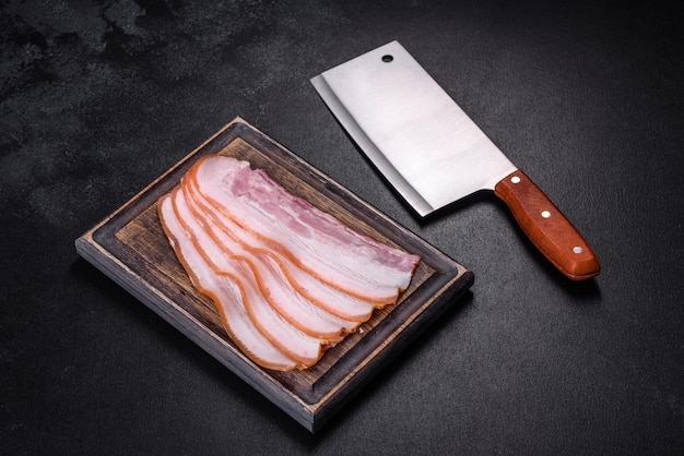 Slices of bacon on a wooden cutting Board Pork meat