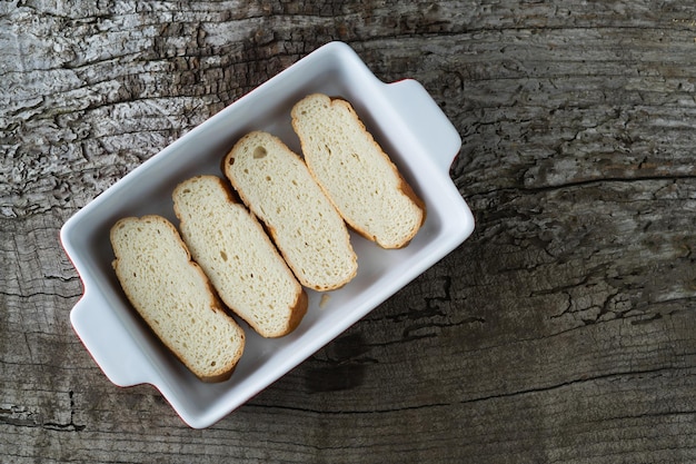 Slices of bread soaking in milk to make torrijas Copy space