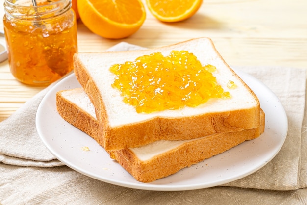 Slices of bread with orange jam for breakfast