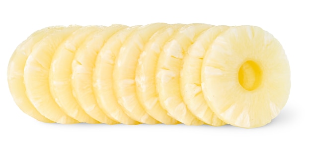 Slices of canned pineapple in a row isolated on white surface