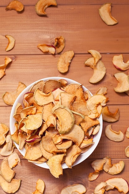 Slices of dried apple on a wooden table winter supplies proper nutrition apple harvest