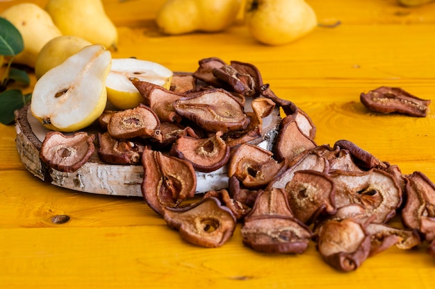 Slices of dried pears delicious snack healthy food closeup on a wooden background