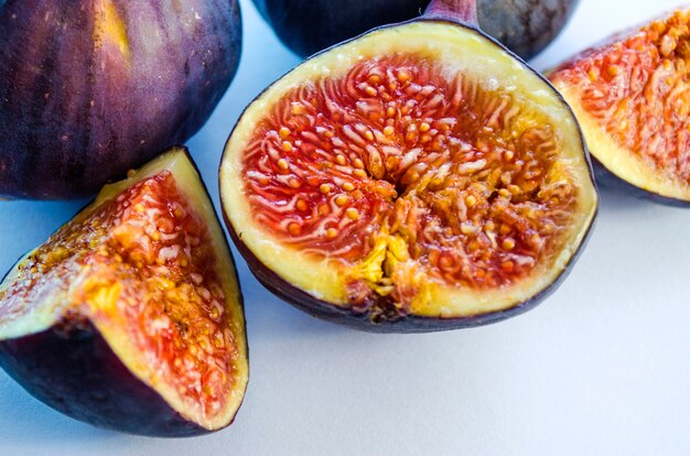 Slices of fresh figs on white background