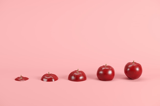 Slices of fresh, red apple on pink background